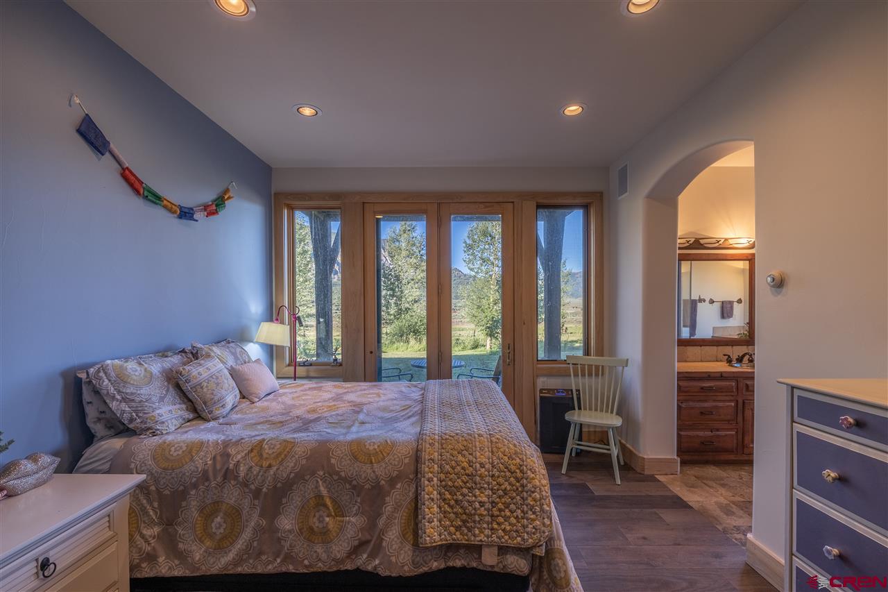 379 Smith Road Crested Butte, CO 81224 - Photo 23 of 35 a bedroom with a large bed and a window
