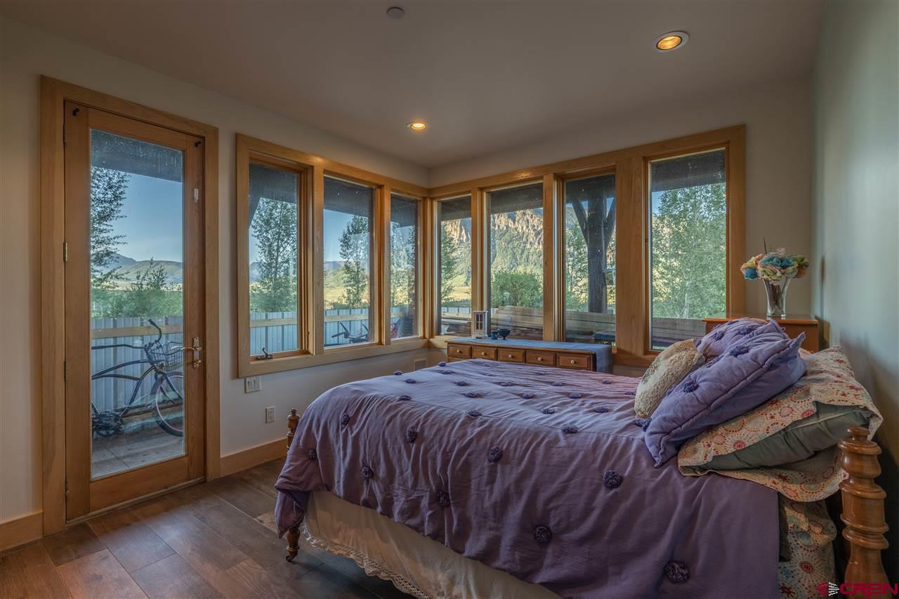 379 Smith Road Crested Butte, CO 81224 - Photo 25 of 35 a bed sitting in a bedroom next to a window
