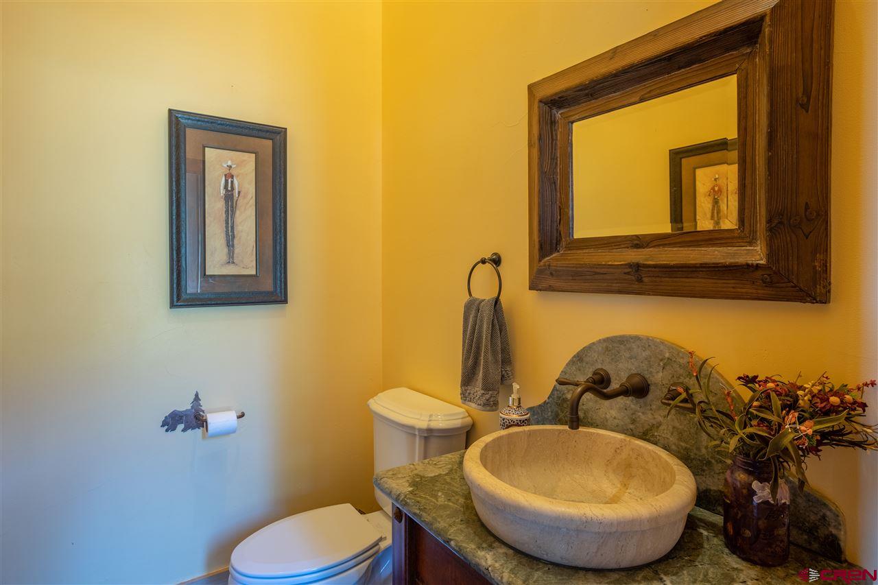 379 Smith Road Crested Butte, CO 81224 - Photo 29 of 35 a bathroom with a toilet mirror and vanity