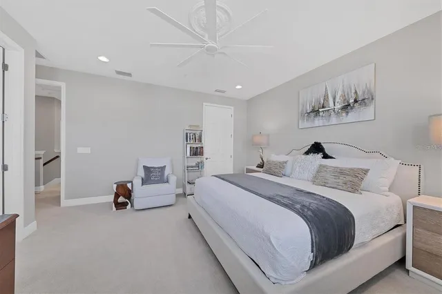 a view of a white house with a large tree