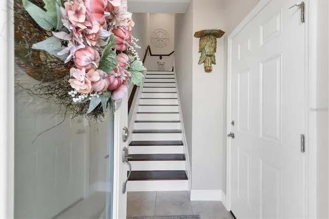 a kitchen with stainless steel appliances granite countertop a dining table chairs sink refrigerator and microwave