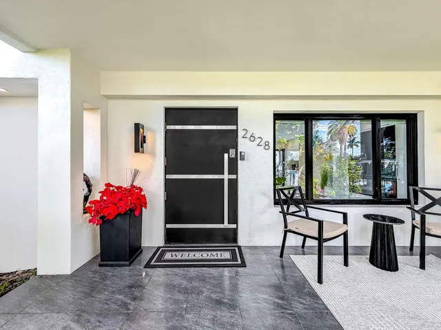 a living room with furniture and a floor to ceiling window