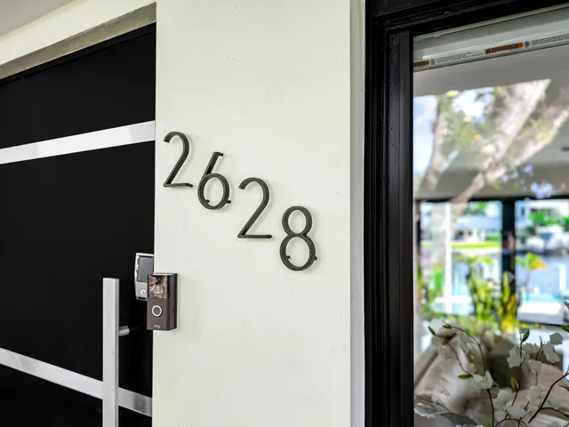 a kitchen with stainless steel appliances kitchen island granite countertop a sink and white cabinets