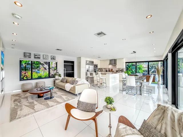 a view of a lake with couches chairs and a table