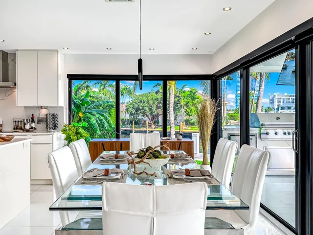 a view of a patio with table and chairs potted plants with sky view