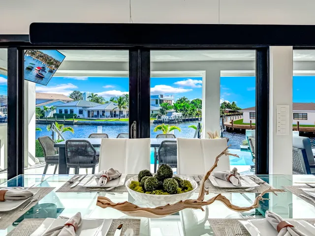 a view of a chairs and table in the patio and a fountain