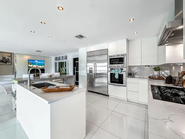a living room with furniture a rug and a floor to ceiling window