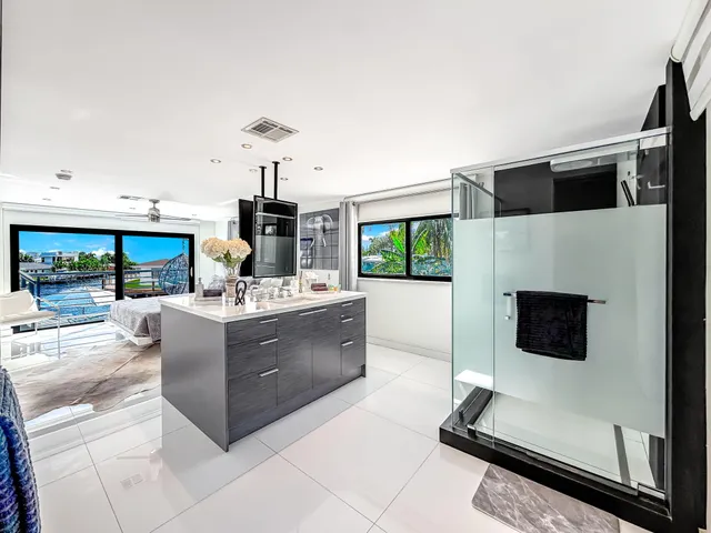 a dining room with furniture and a floor to ceiling window