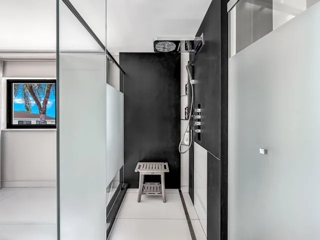 a view of swimming pool with a chairs and table in the patio