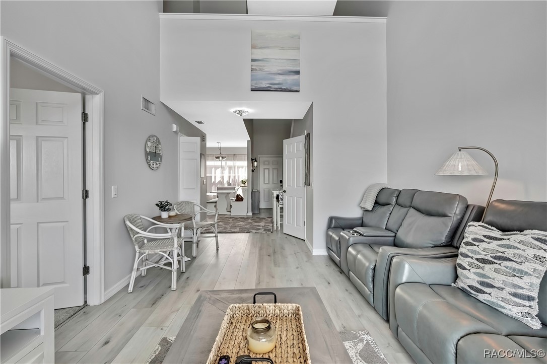 2855 North Rivers Edge Boulevard, Unit 213 Crystal River, FL 34429 - Photo 12 of 62 a living room with furniture and wooden floor