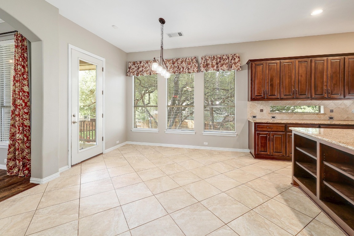 1900 Alamo Bound Leander, TX 78641 - Photo 12 of 38 a kitchen with stainless steel appliances a stove sink and cabinets