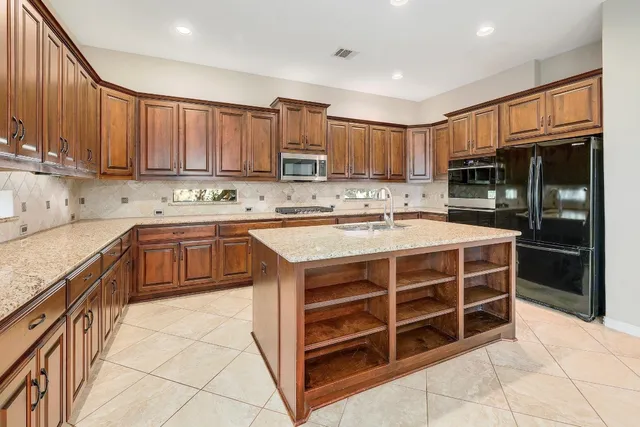 a kitchen with stainless steel appliances a stove sink and cabinets