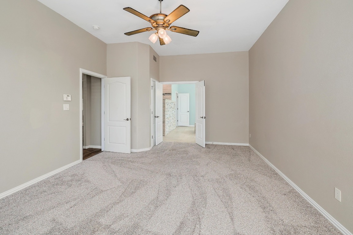 1900 Alamo Bound Leander, TX 78641 - Photo 18 of 38 an empty room with closet and a chandelier fan
