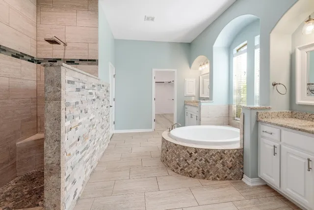 a large bathroom with a granite countertop sink a toilet and a shower