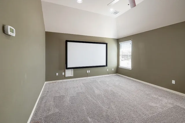 a view of an empty room with windows