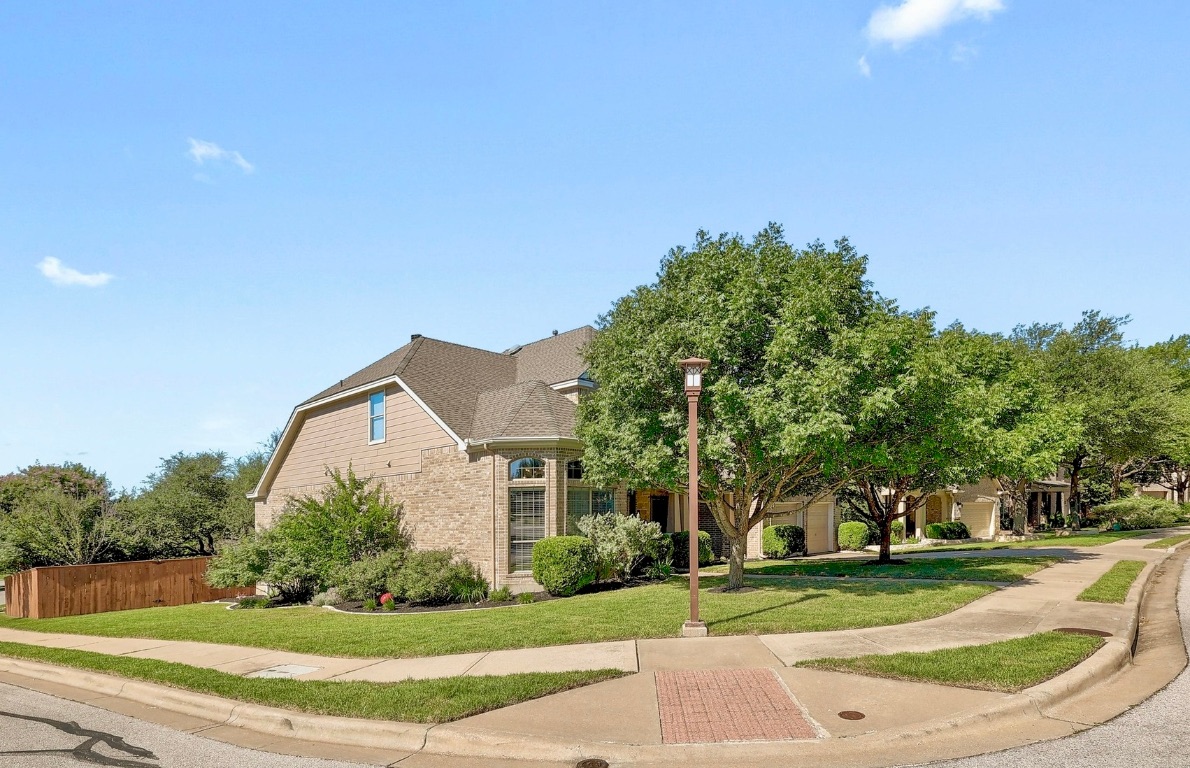 1900 Alamo Bound Leander, TX 78641 - Photo 3 of 38 a view of a white house next to a yard with big trees