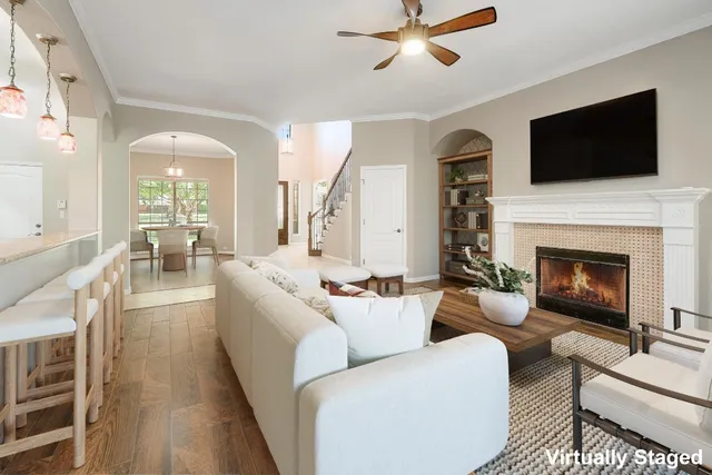 a living room with furniture fireplace and flat screen tv