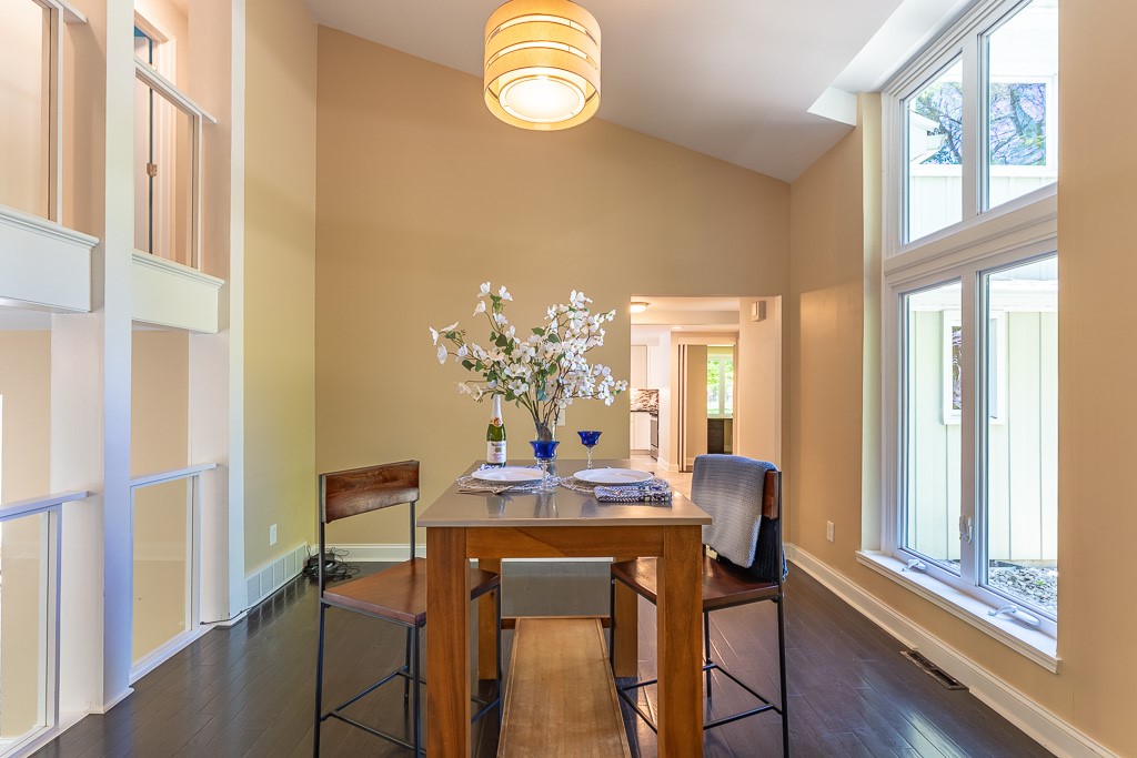 220 Hibiscus Drive Rochester, NY 14618 - Photo 5 of 50 Vaulted ceilings and gleaming hardwood floors create a space that feels both grand and inviting, like a modern gallery suspended within the home.