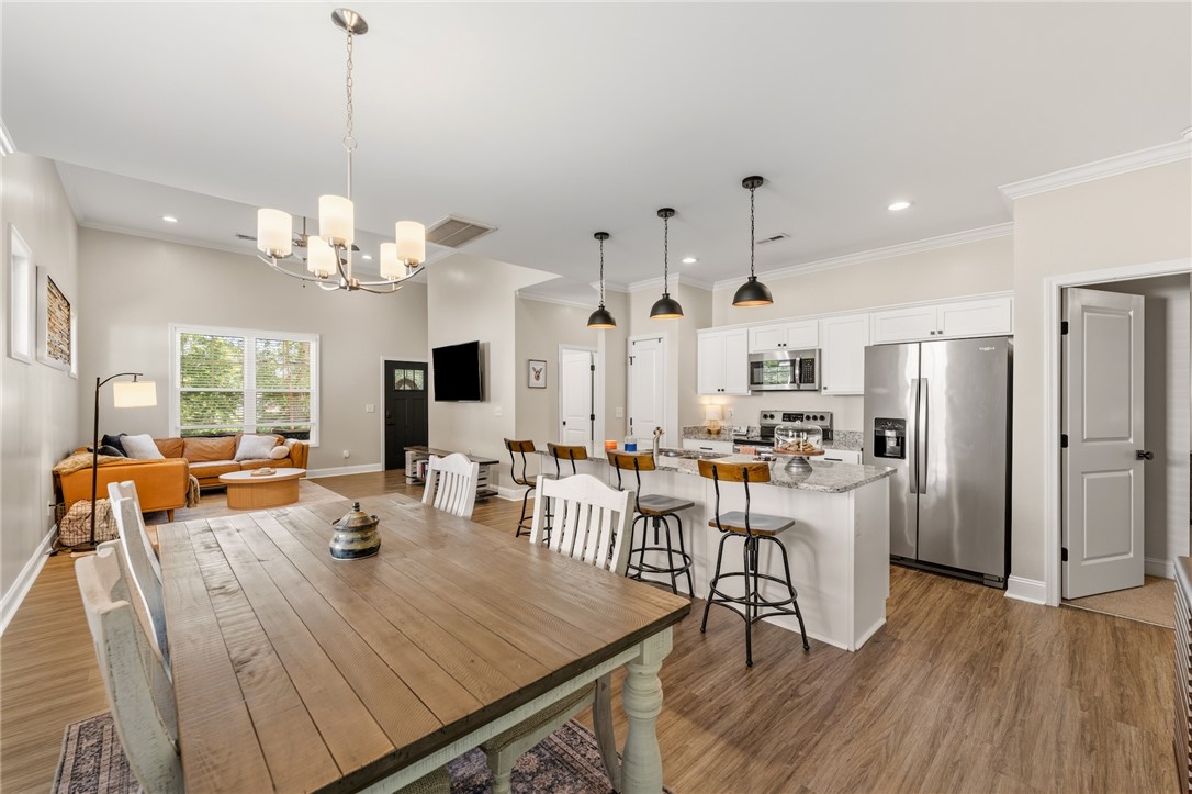 47 A Main Street Pelzer, SC 29669 - Photo 14 of 27 This open concept living space features a dining area, kitchen, and living room perfect for gathering.