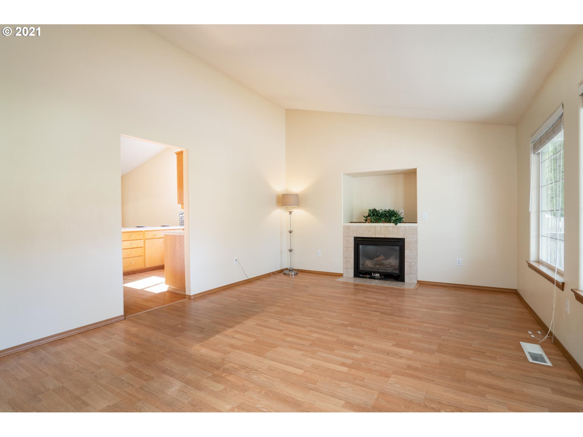 1136 Southwest Ivory Loop, Unit 19 Gresham, OR 97080 - Photo 3 of 24 a view of an empty room with a window