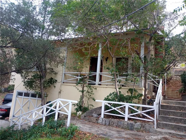 an outdoor space with seating area and trees