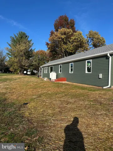 a view of a pool with a house