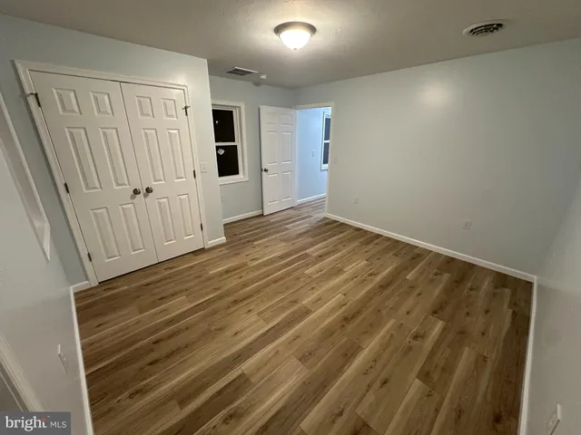 a view of room with wooden floor and window