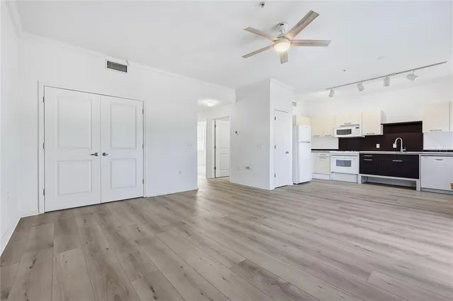 a view of a kitchen with a sink and a refrigerator