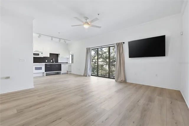 a view of a livingroom with furniture flat screen tv and wooden floor