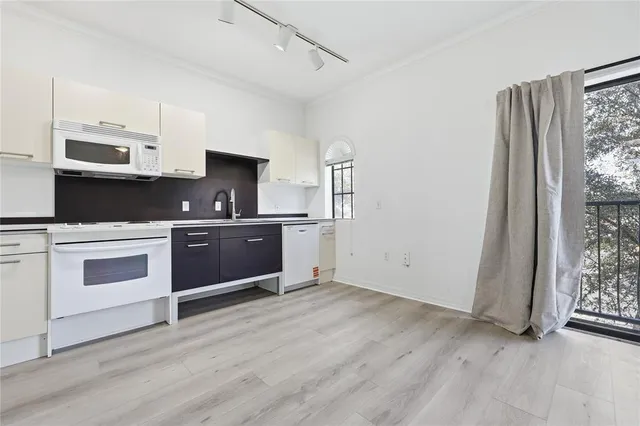 a kitchen with a sink and a stove top oven