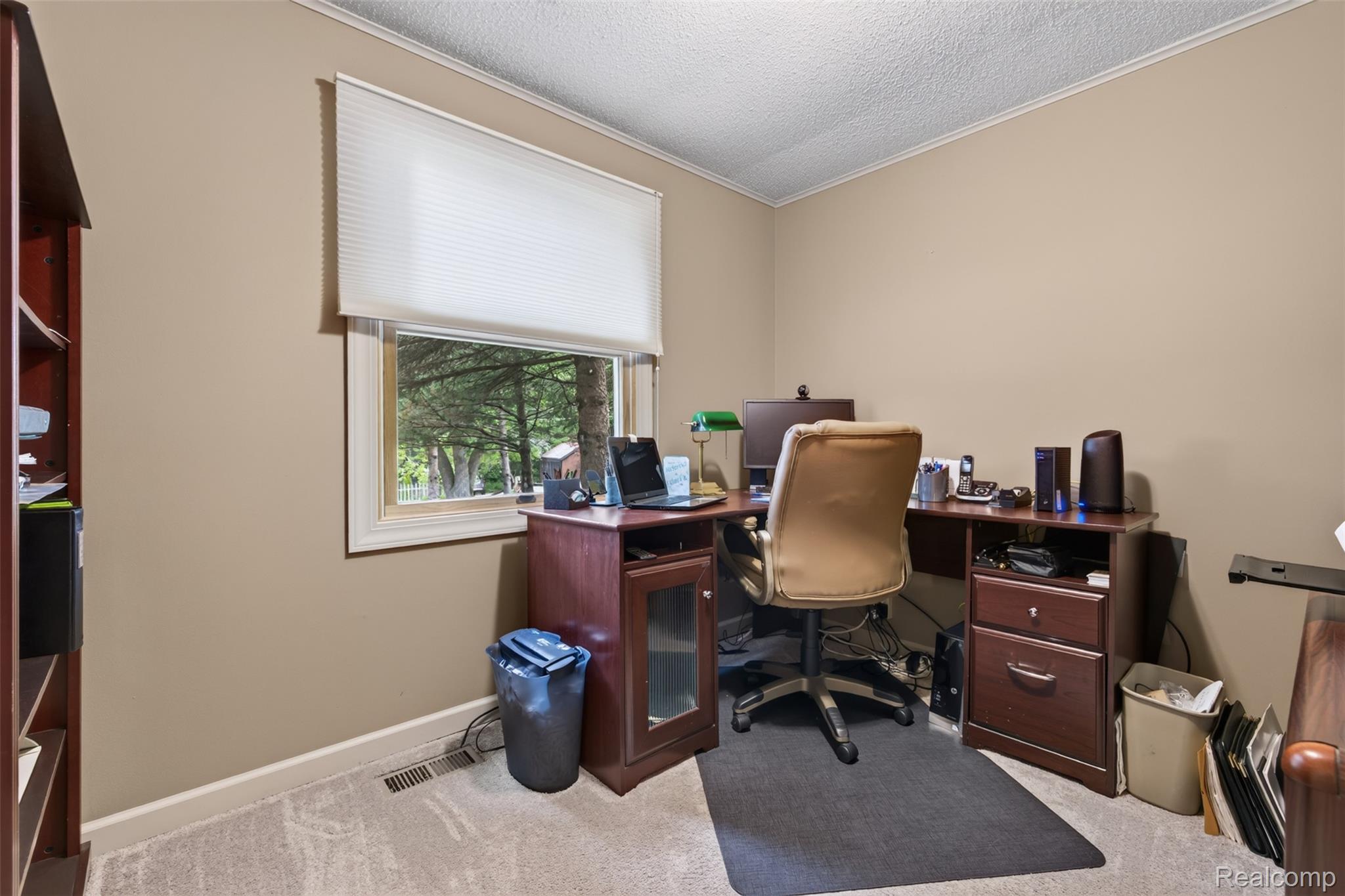 5977 Anglers Road Ortonville, MI 48462 - Photo 15 of 63 Carpeted room with neutral wall tones, featuring a window with cellular shades and a treetop exterior