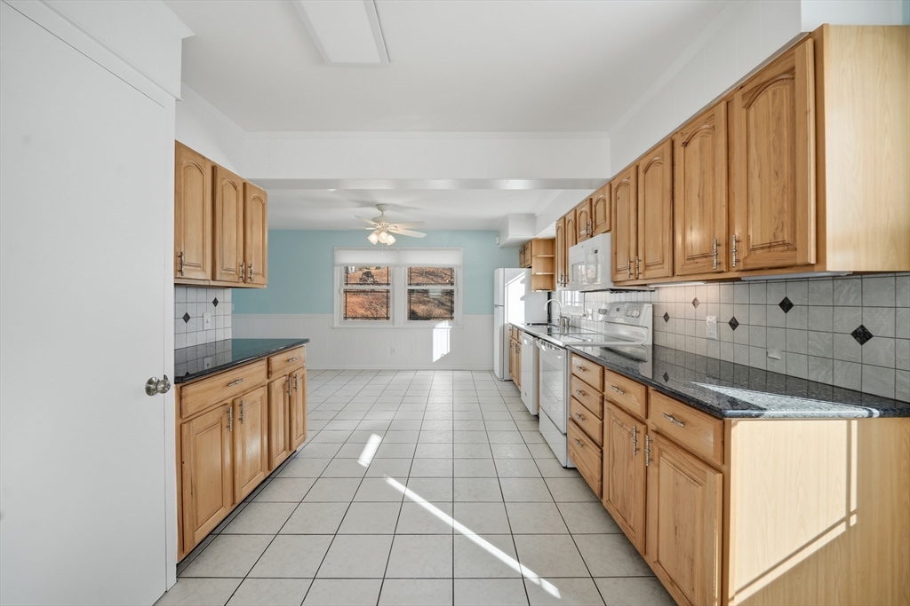 88 Verdugo Street West Springfield, MA 01089 - Photo 13 of 42 a large kitchen with stainless steel appliances granite countertop a stove and a sink