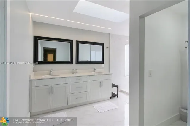 a bathroom with 2 sink and a mirror