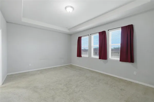 a bedroom with a bed and a potted plant