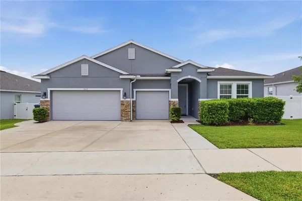 a front view of a house with a yard and garage