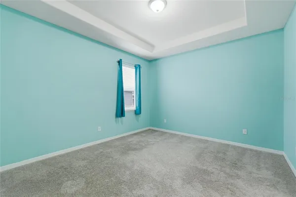 a bedroom with a bed and a book shelf