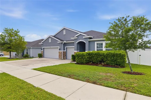 a front view of a house with a yard and garage