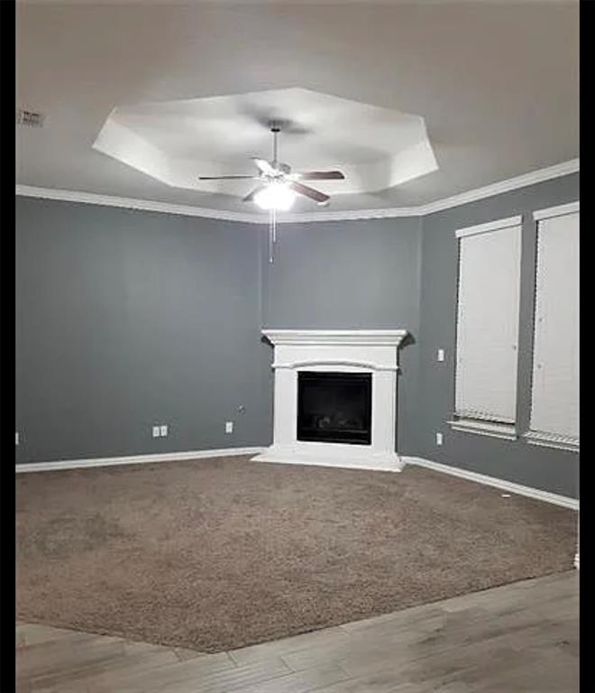 3905 Gennaker Drive Denton, TX 76210 - Photo 5 of 13 an empty room with a fireplace and chandelier fan