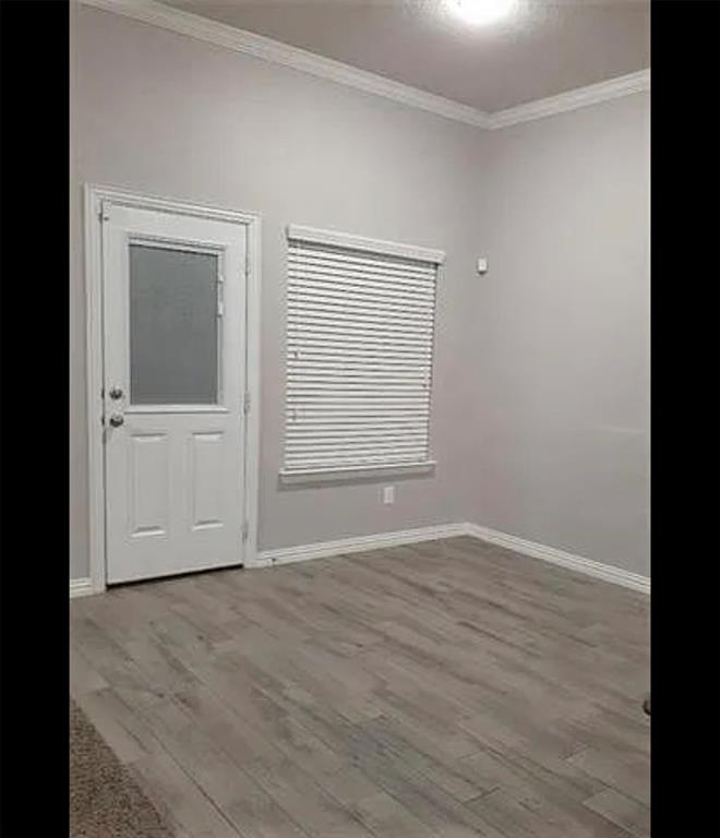 3905 Gennaker Drive Denton, TX 76210 - Photo 7 of 13 an empty room with wooden floor and windows
