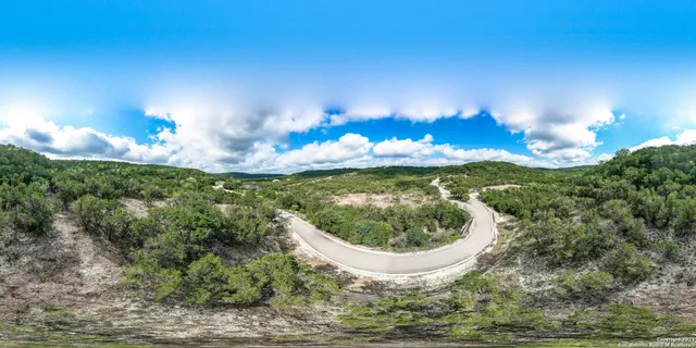 a view of a patio with a table chairs and a yard