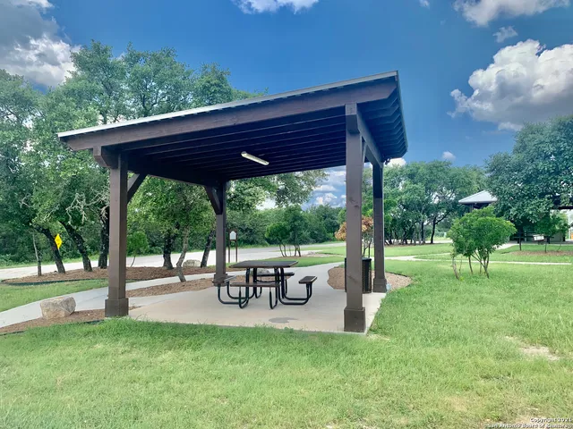a view of a backyard with table and chairs