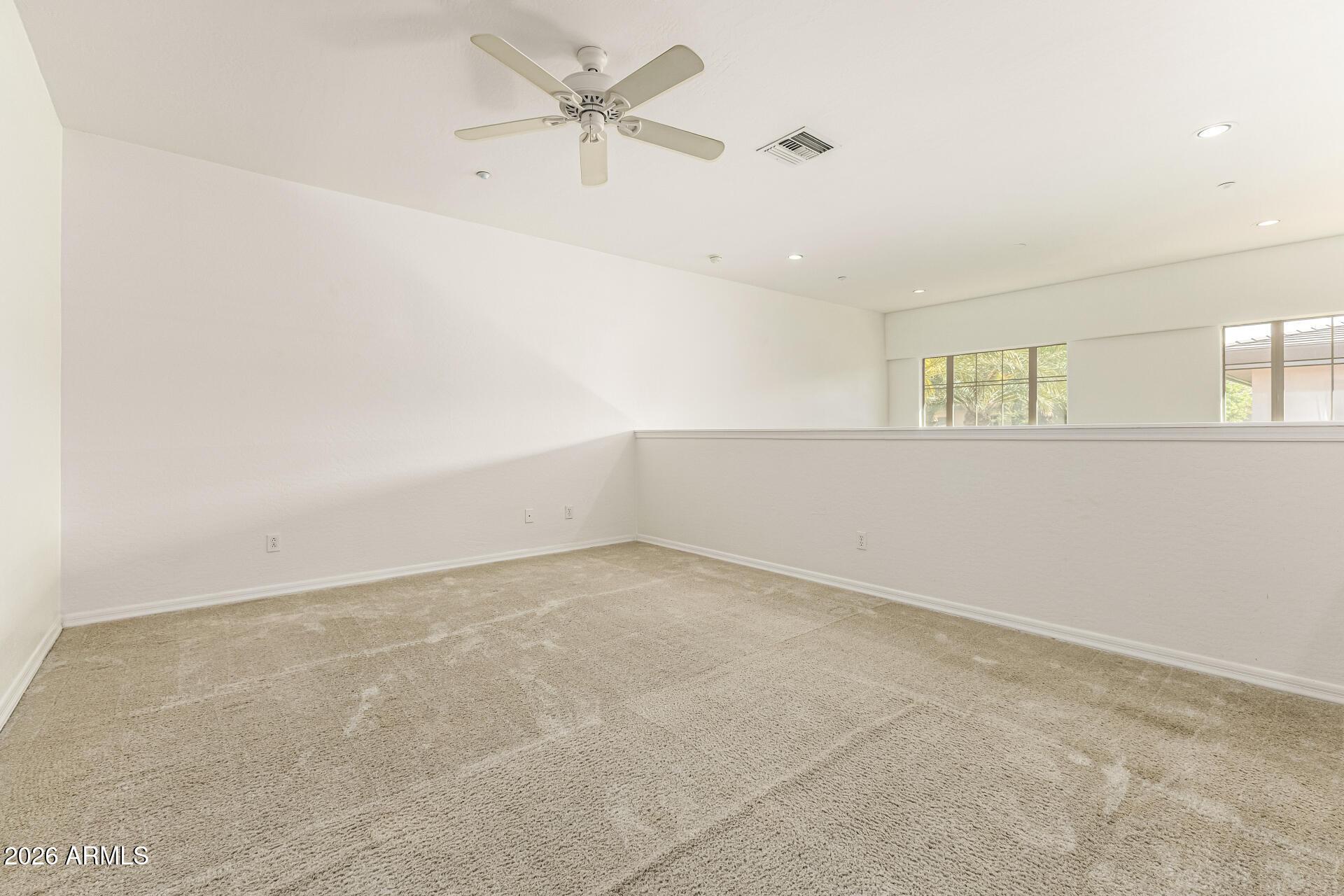 6940 East Cochise Road, Unit 1043 Paradise Valley, AZ 85253 - Photo 17 of 35 an empty room with a empty space and a ceiling fan