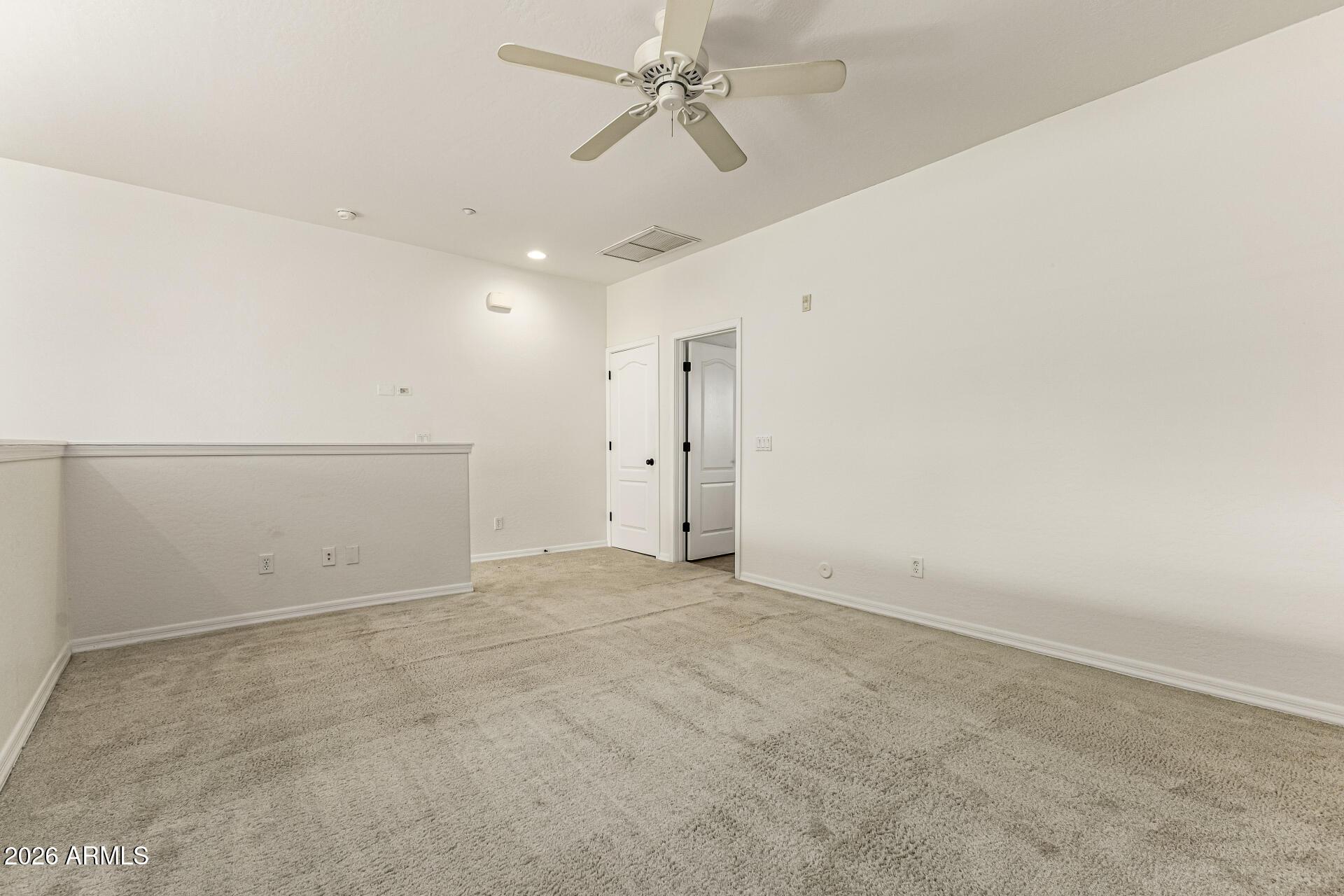 6940 East Cochise Road, Unit 1043 Paradise Valley, AZ 85253 - Photo 18 of 35 an empty room with chandelier fan and closet area