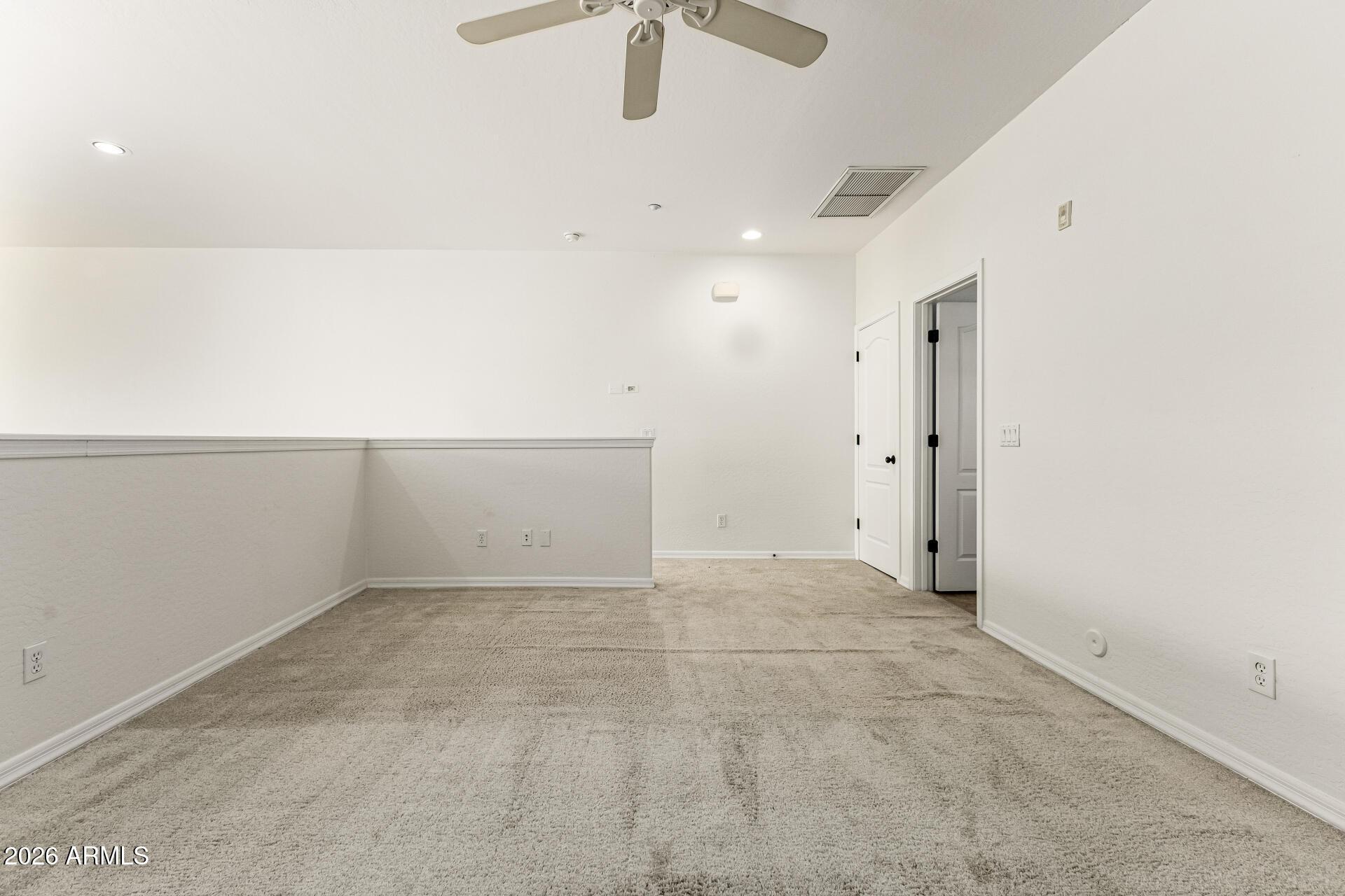 6940 East Cochise Road, Unit 1043 Paradise Valley, AZ 85253 - Photo 19 of 35 an empty room with a ceiling fan and carpet