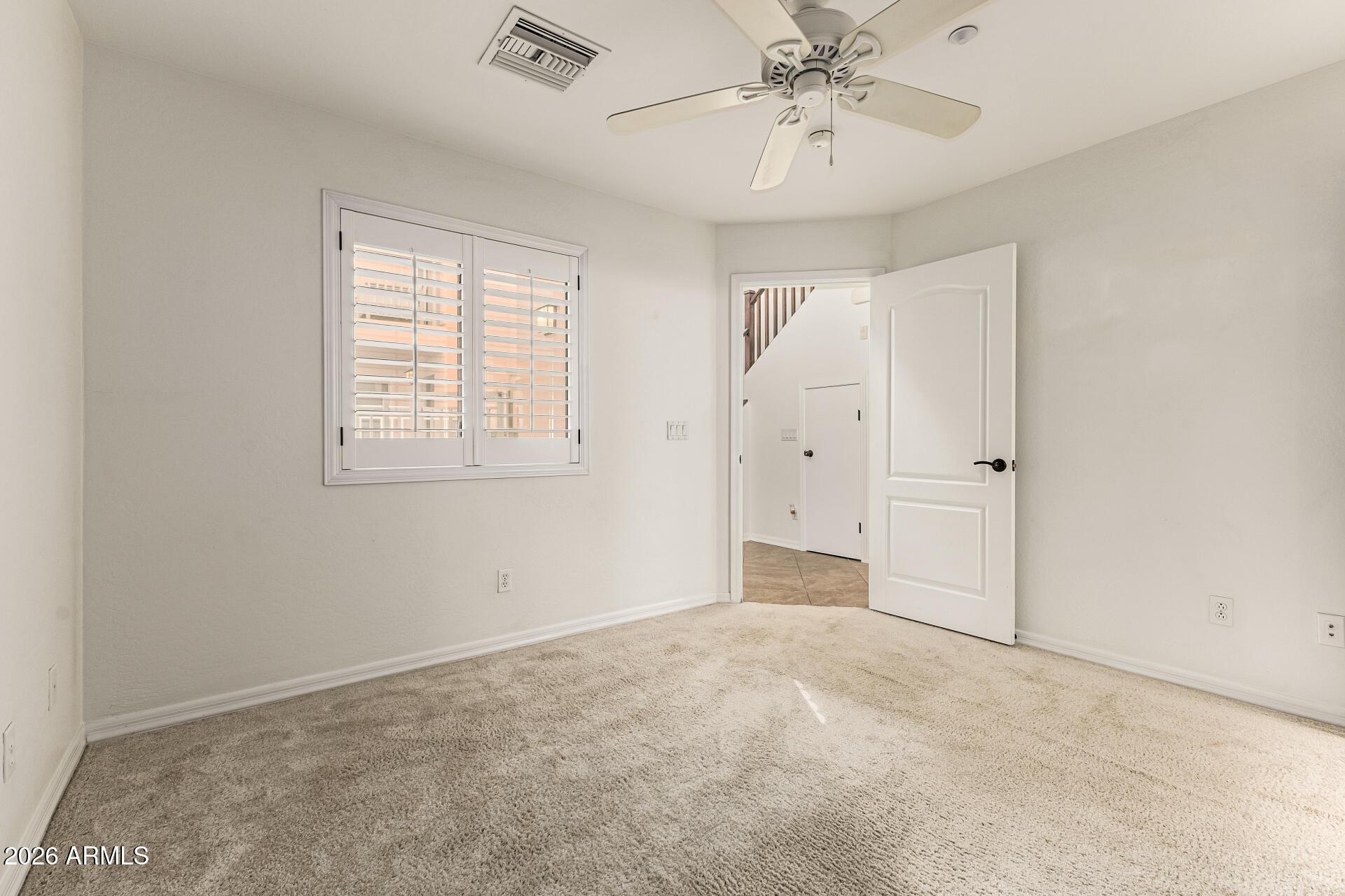 6940 East Cochise Road, Unit 1043 Paradise Valley, AZ 85253 - Photo 21 of 35 an empty room with fan and windows