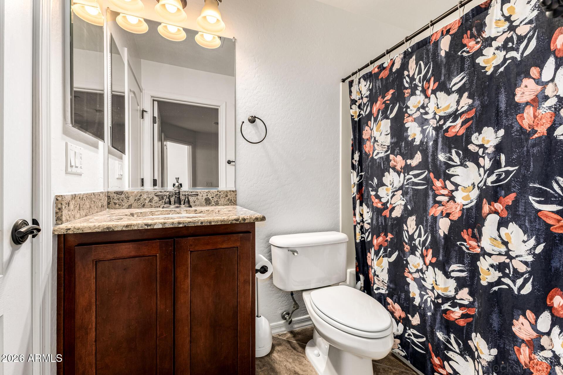 6940 East Cochise Road, Unit 1043 Paradise Valley, AZ 85253 - Photo 22 of 35 a bathroom with a toilet sink and mirror