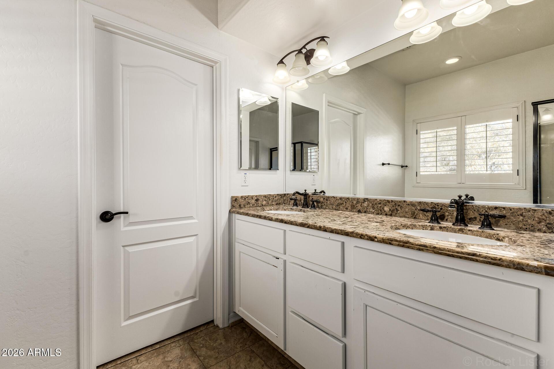 6940 East Cochise Road, Unit 1043 Paradise Valley, AZ 85253 - Photo 24 of 35 a bathroom with a granite countertop sink double and mirror
