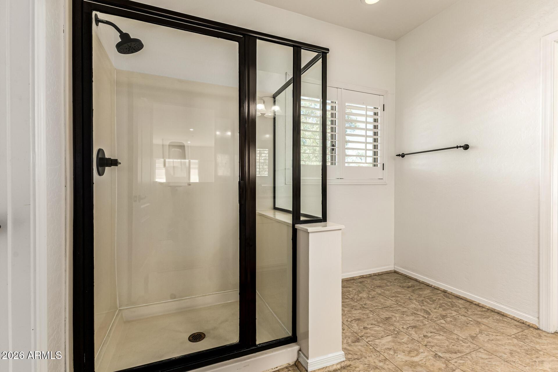 6940 East Cochise Road, Unit 1043 Paradise Valley, AZ 85253 - Photo 25 of 35 a bathroom with a glass shower door