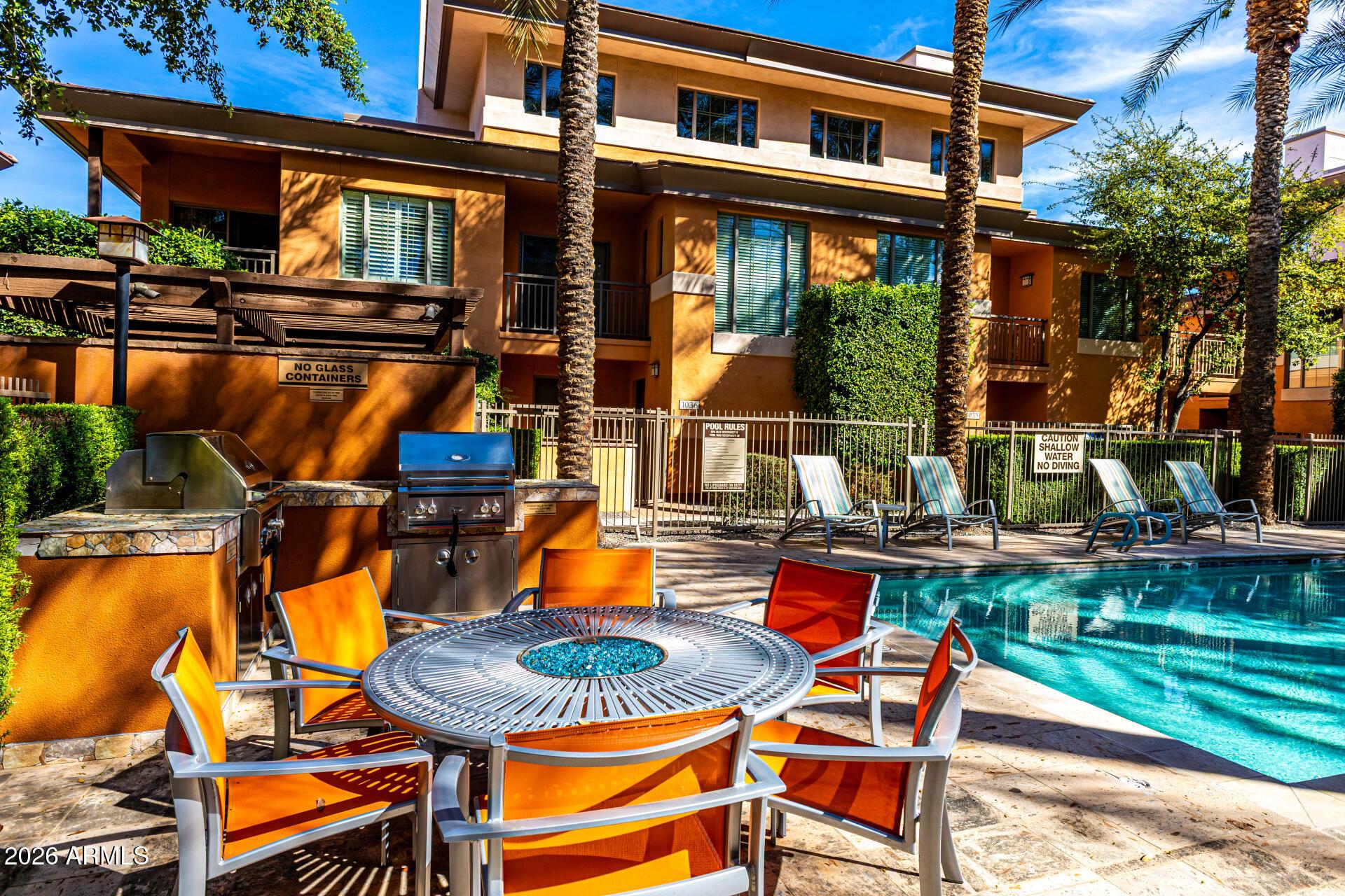 6940 East Cochise Road, Unit 1043 Paradise Valley, AZ 85253 - Photo 32 of 35 a wooden bench sitting in front of a house