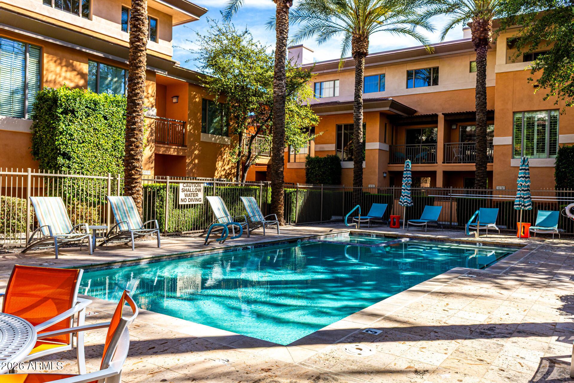 6940 East Cochise Road, Unit 1043 Paradise Valley, AZ 85253 - Photo 33 of 35 a view of a house with swimming pool and sitting area